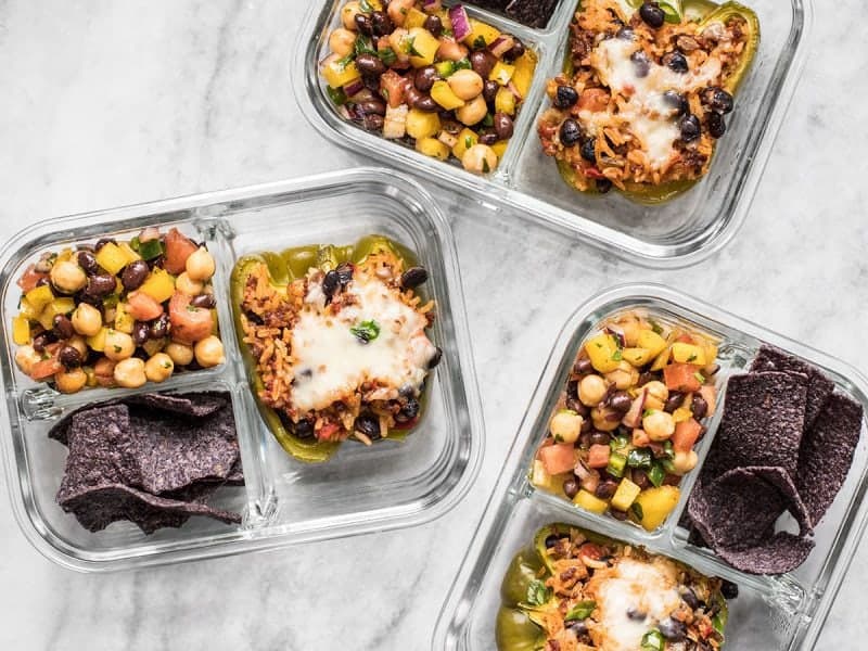Stuffed bell pepper meal prep containers scattered about