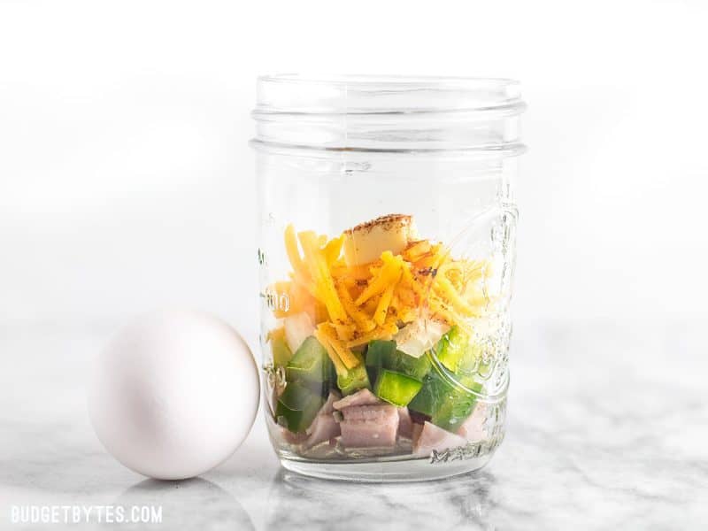 A jar full of ingredients for Make Ahead Microwave Breakfast Scrambles 