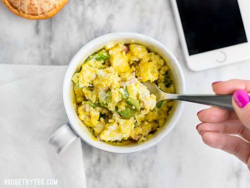 A Make Ahead Microwave Breakfast Scramble being eaten.