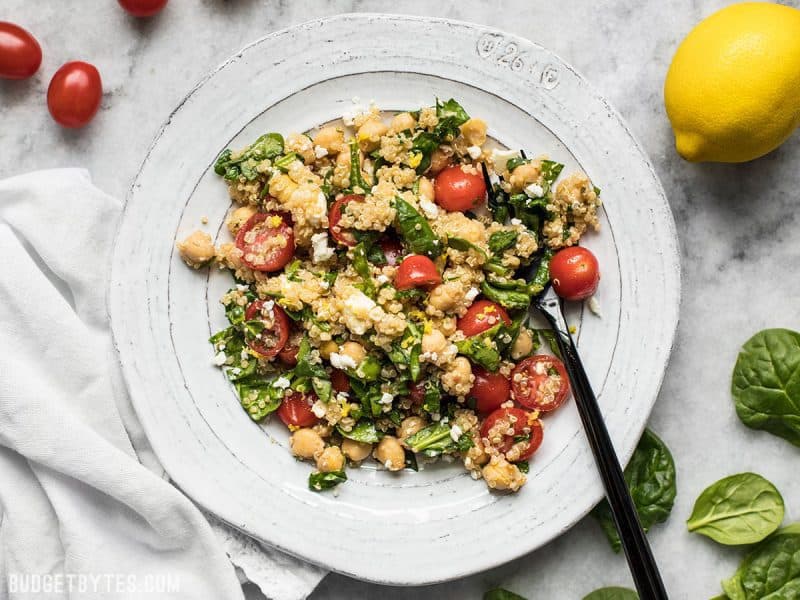 Top view of a plate of Spinach Chickpea and Quinoa Salad with fork 