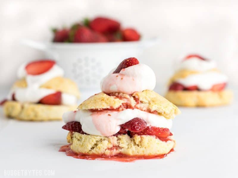 Three Strawberry Shortcakes with strawberry juice drizzled over top