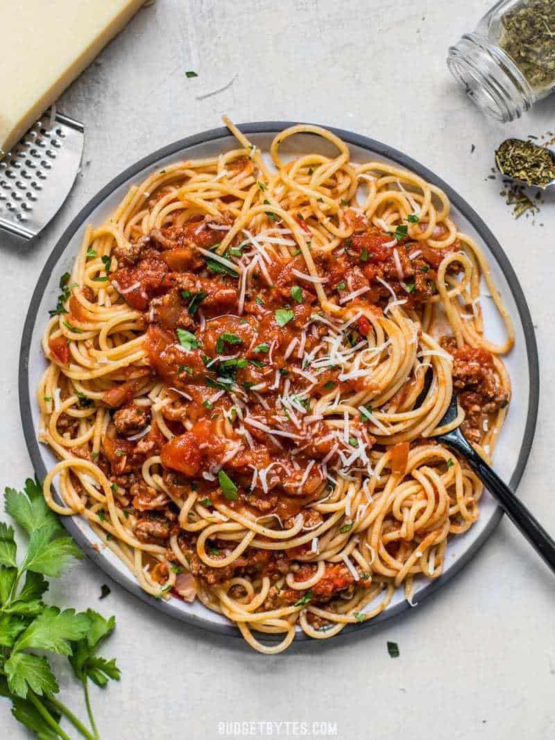 I huge plate full of spaghetti with the best Weeknight Pasta Sauce, Parmesan, and parsley