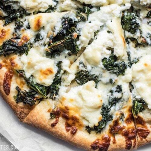 Garlicky greens and creamy ricotta pair perfectly on this light and fresh Garlicky Kale and Ricotta Pizza. It’s the perfect pizza for summer! BudgetBytes.com