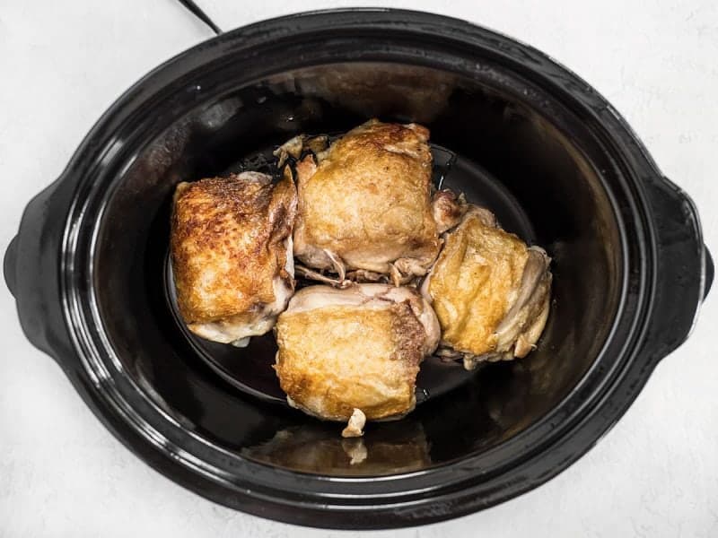 Place Browned Chicken Thighs in Slow Cooker