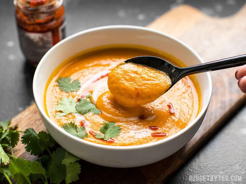 Close up view of a spoonful of thick Thai Coconut Curry Carrot Soup