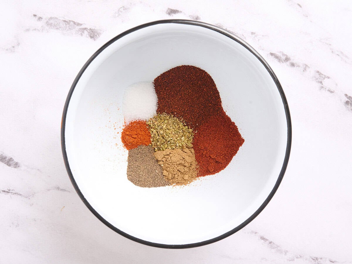 The ingredients to make homemade taco seasoning in a bowl.