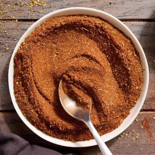 Homemade taco seasoning in a bowl with a spoon.
