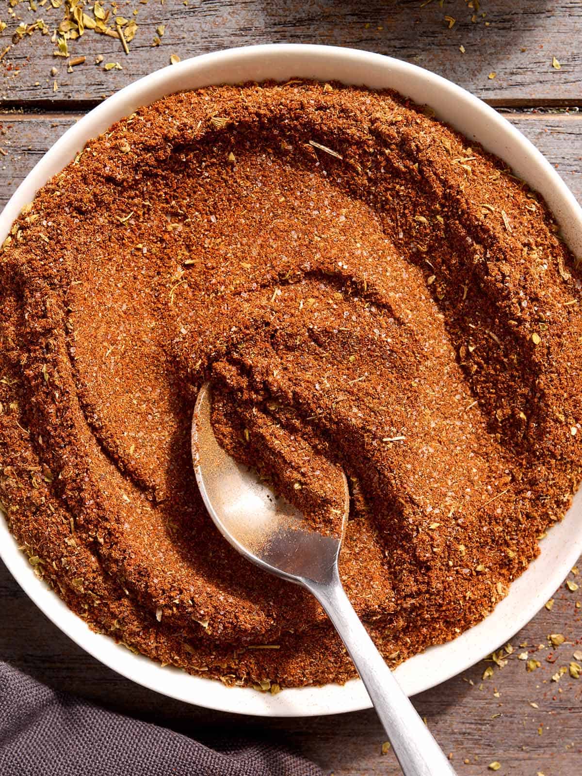 Homemade taco seasoning in a bowl with a spoon.