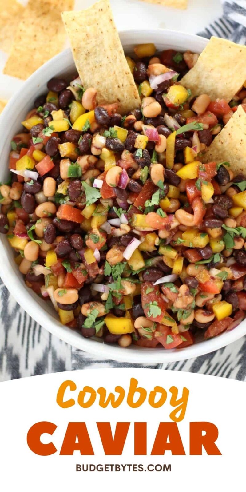 close up of a bowl of cowboy caviar with chips in the side