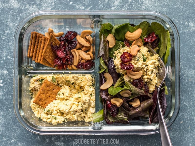 One Curried Tofu Salad Meal Prep container being eaten