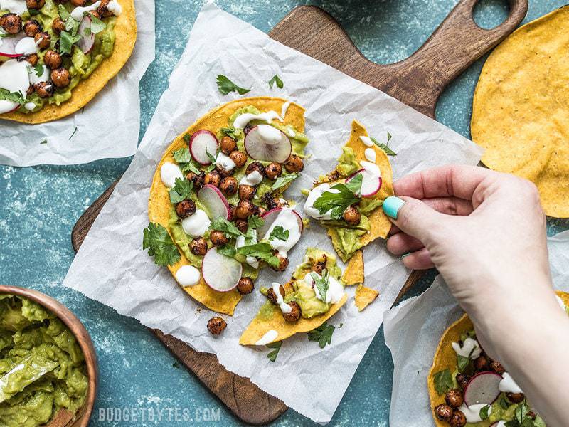 Spiced Chickpea Tostadas being broken into pieces 