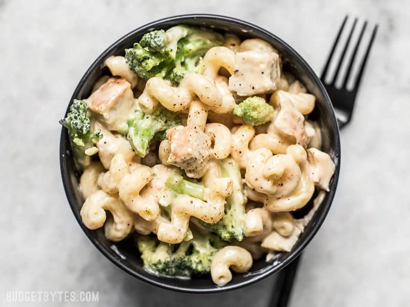 Close up of a bowl of White Cheddar Mac and Cheese with broccoli and chicken