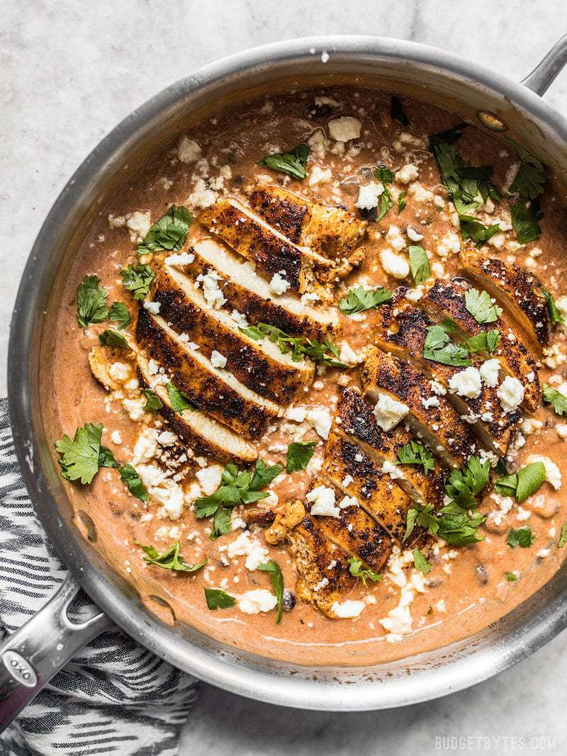 Finished creamy salsa chicken skillet with cilantro and cheese sprinkled over top.