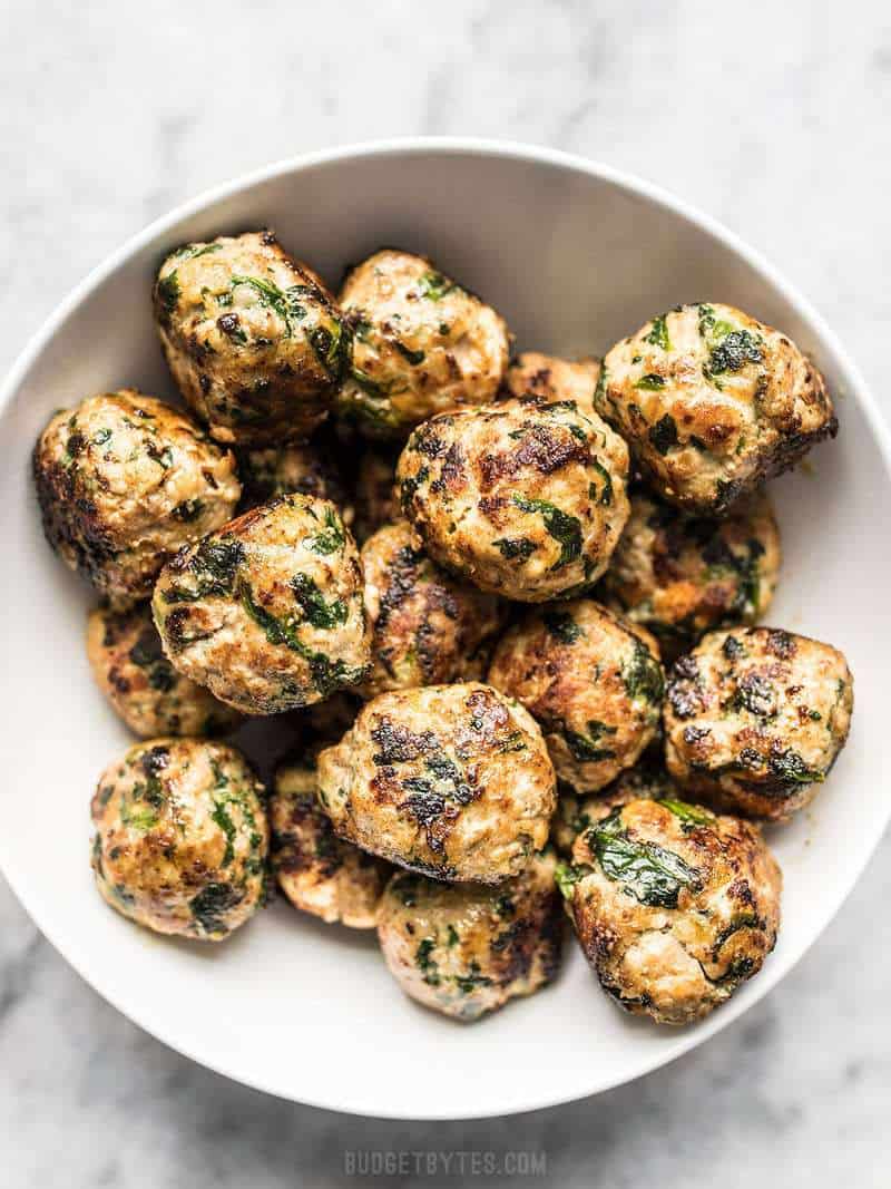 Spinach and Feta Turkey Meatballs are an easy way to add flavor and protein to your meal using inexpensive ground turkey. Perfect for meal prep! Budgetbytes.com