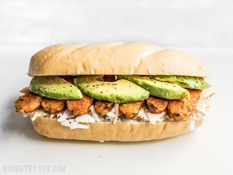 Buffalo Tempeh Sandwich on a Cutting Board