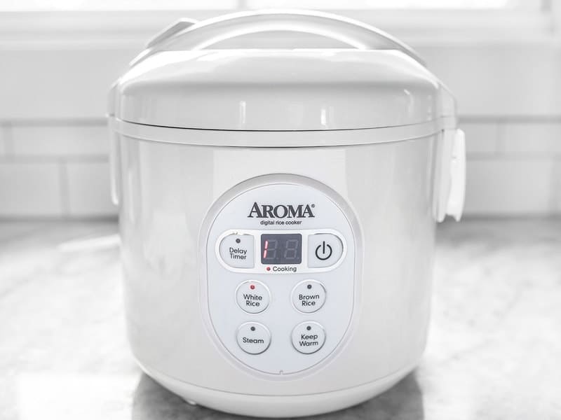 Rice cooker cooking, with one minute left on timer