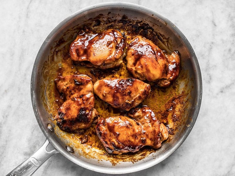 Finished Sweet and Spicy Glazed Chicken Thighs in the skillet