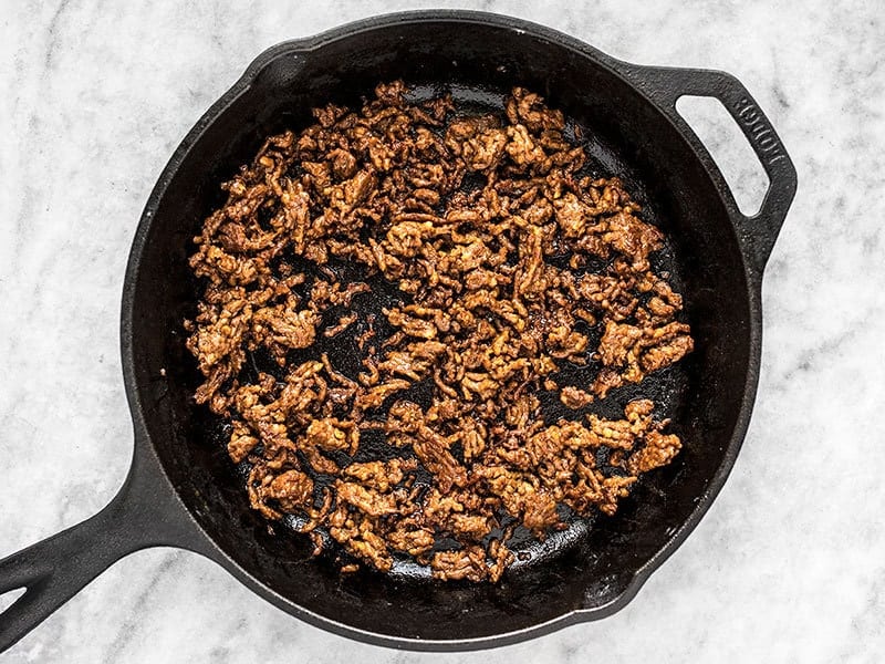 Crispy browned chorizo in a cast iron skillet