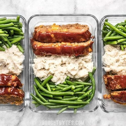 This Cheeseburger Meatloaf Meal Prep is an easy American classic meal that you'll look forward to each day. Toss the TV dinners and make your own! Budgetbytes.com