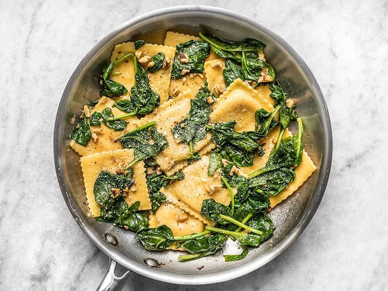 Finished Ravioli with Sage Brown Butter Sauce, Spinach, and Walnuts