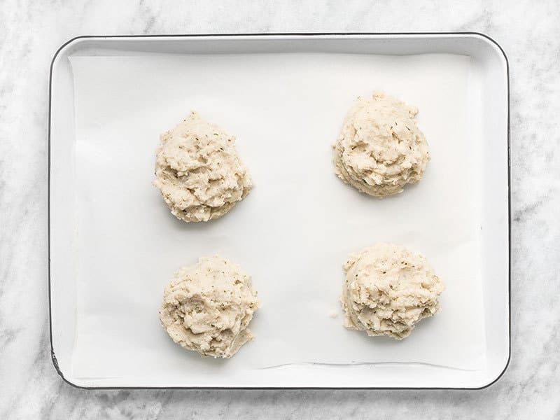 Portioned Mashed Potatoes ready to freeze on a parchment lined baking sheet