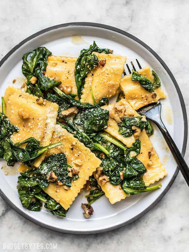 Big plate of Ravioli with Sage Brown Butter Sauce, spinach, and walnuts