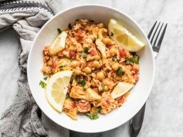 A hearty bowl of Rice Cooker Spanish Chickpeas and Rice with fresh lemon and parsley