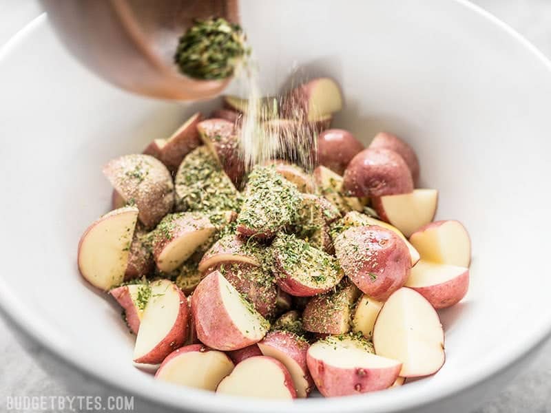 Garlic Herb Seasoning Blend being added to potatoes