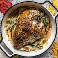 Herb-Infused Cider Roasted Turkey Breast with Apples and Onions in casserole dish
