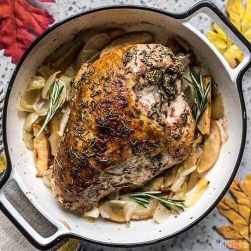 Herb-Infused Cider Roasted Turkey Breast with Apples and Onions in casserole dish