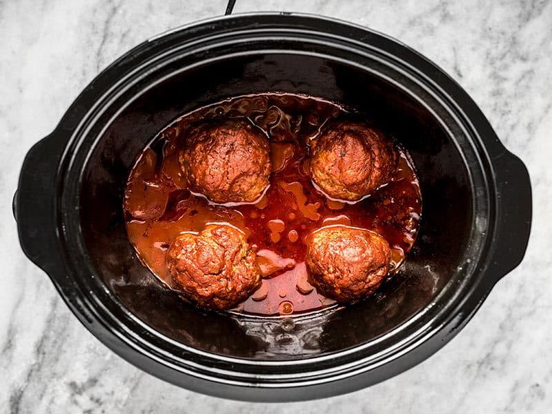 Cooked Giant Slow Cooker Meatballs with sauce in the slow cooker