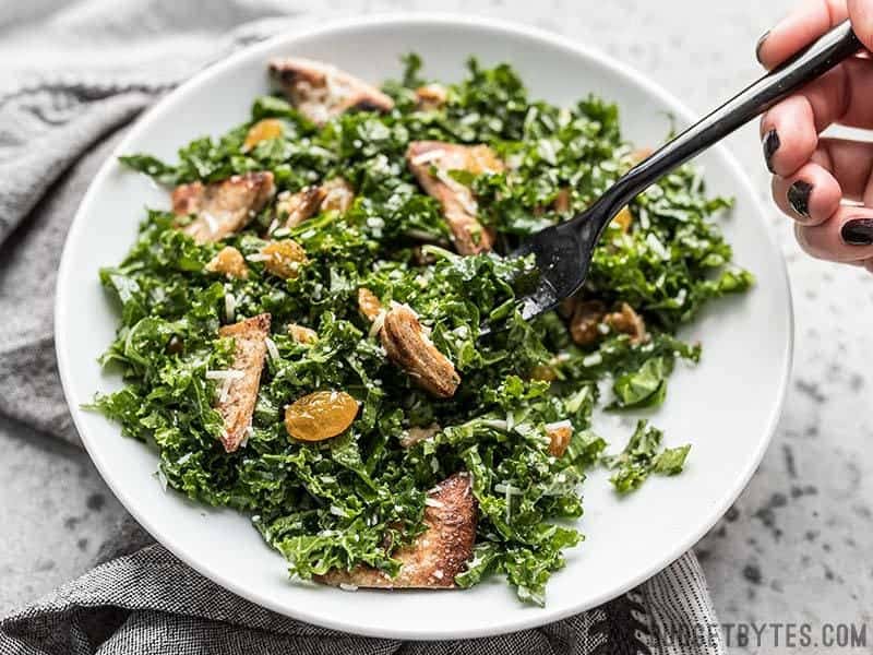 Kale and Toasted Pita Salad with Parmesan in the process of being eaten.