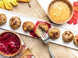 Turkey and Stuffing Meatballs dipped in cranberry sauce and gravy.