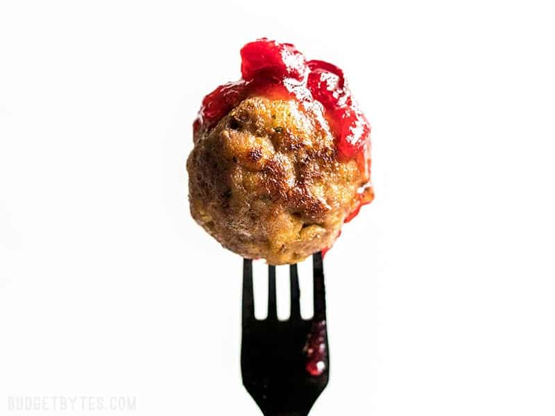A Turkey and Stuffing Meatballs dipped in cranberry sauce.