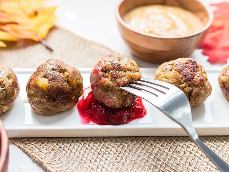 Turkey and Stuffing Meatballs served as appetizers and dipped in cranberry sauce.
