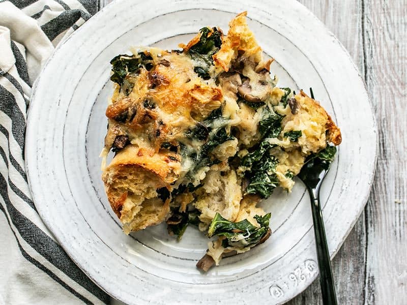 One slice of Kale Swiss and Mushroom Strata on a plate
