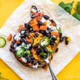 One Loaded Sweet Potato being eaten with a fork.