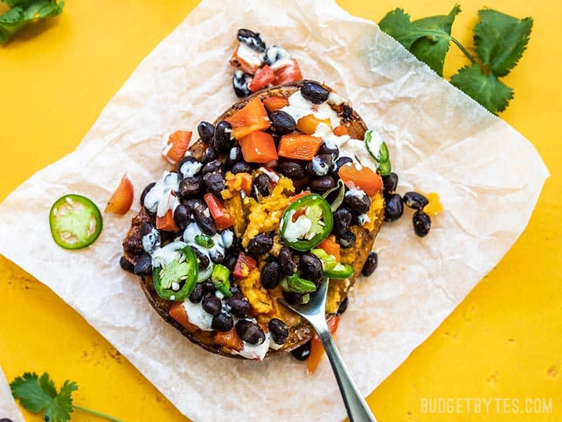 One Loaded Sweet Potato being eaten with a fork.