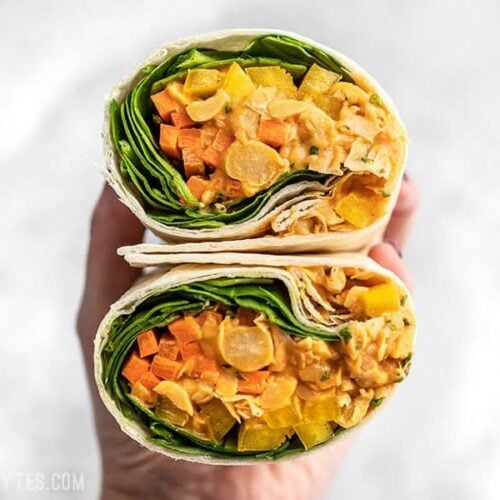 A Sriracha Chickpea Salad Wrap cut open, with open sides facing viewer.