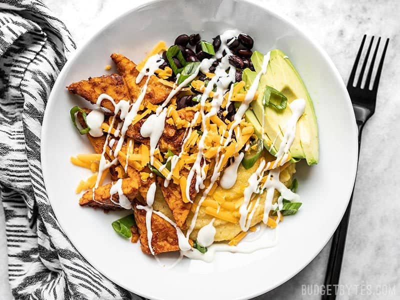 A prepared Sweet and Spicy Tempeh Bowl with ranch drizzle.