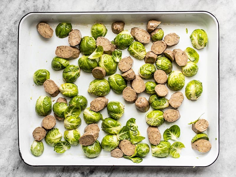Brussels Sprouts and Sausage on a baking sheet ready to roast