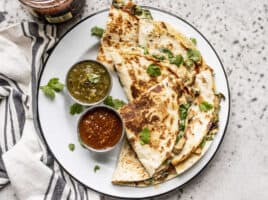 Creamy Chicken and Spinach Quesadillas on a plate with two types of salsa