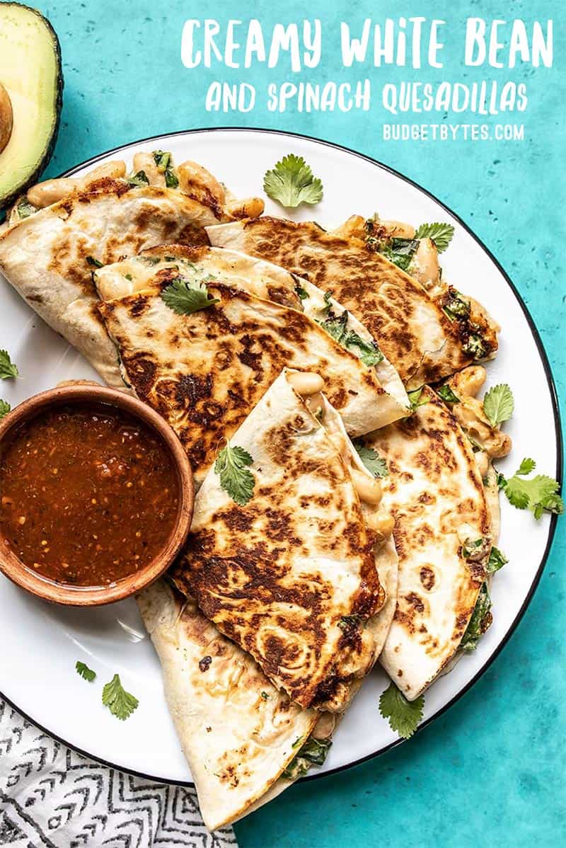 A plate of Creamy White Bean and Spinach Quesadillas with red salsa