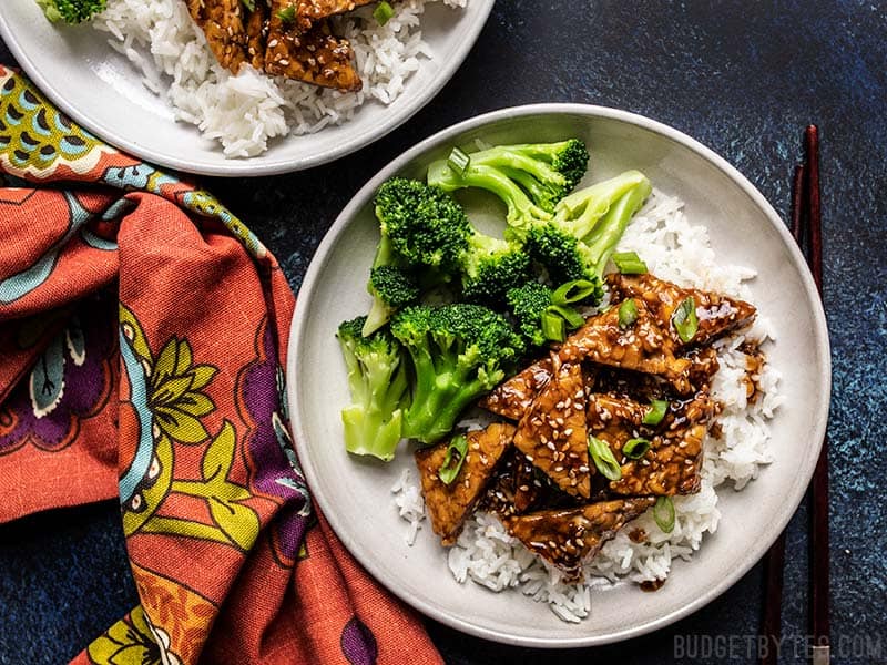Sesame Tempeh Bowls with rice and broccoli, and a colorful napkin