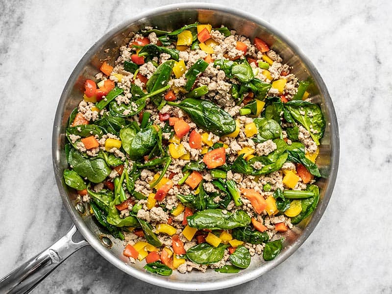 Vegetables added to the ground turkey and garlic in the skillet.