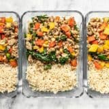 Three rectangular glass meal prep containers with Ground Turkey Stir Fry and Brown Rice