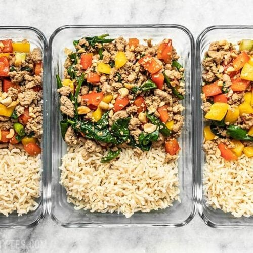 Three rectangular glass meal prep containers with Ground Turkey Stir Fry and Brown Rice