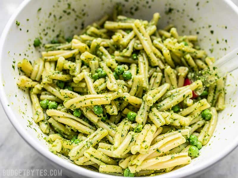 Parsley Pesto Pasta with peas close up in a large bowl