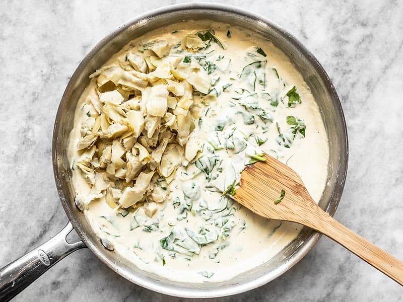 Add Chopped Artichokes to the creamy spinach sauce