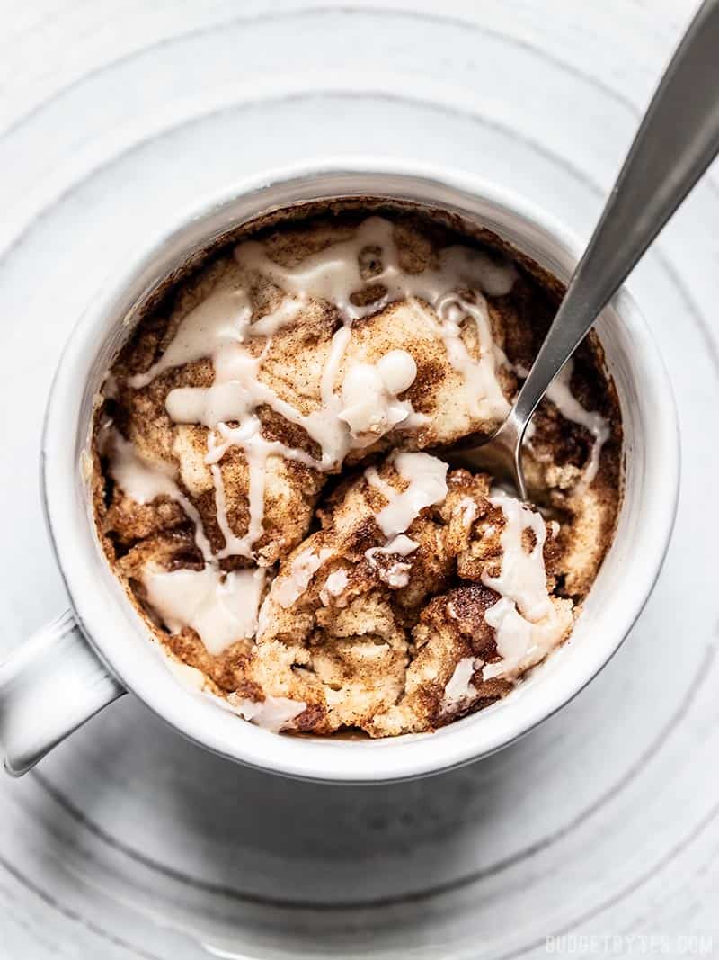 Overhead view of a spoon digging into a Cinnamon Nut Swirl Mug Cake